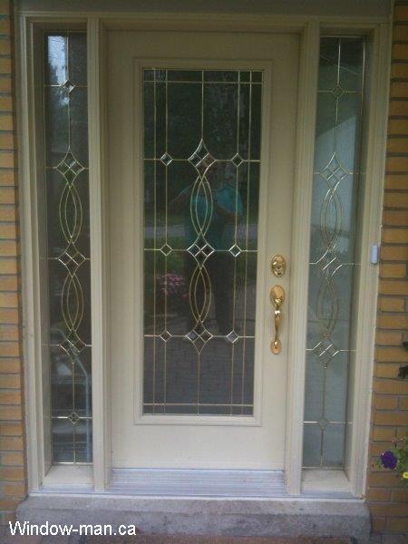 Single front door installation. Main entry steel insulated cream beige full glass and two sidelights. Custom stained glass. Beveled Glass with brass caming. Installed